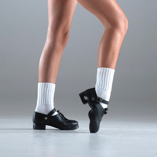 Flexibility demonstration of black Irish dance shoes with suede soles