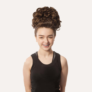 Front view of brown loose curl bun wig on dancer