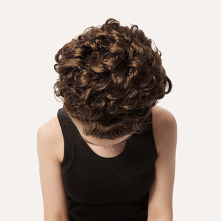 Top-down view of brown loose curl bun wig texture